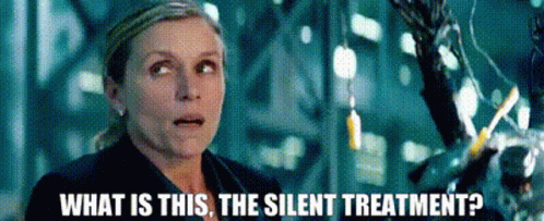A Woman Is Standing In Front Of A Machine And Asking What Is This The Silent Treatment ? GIF