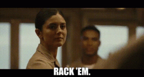 A Woman Is Standing In Front Of A Man And Says Rack 'Em GIF