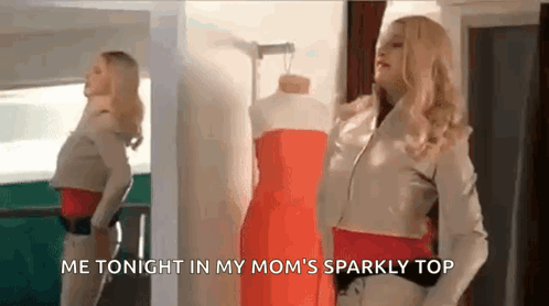 a woman is standing in front of a mannequin wearing a red dress in front of a mirror .