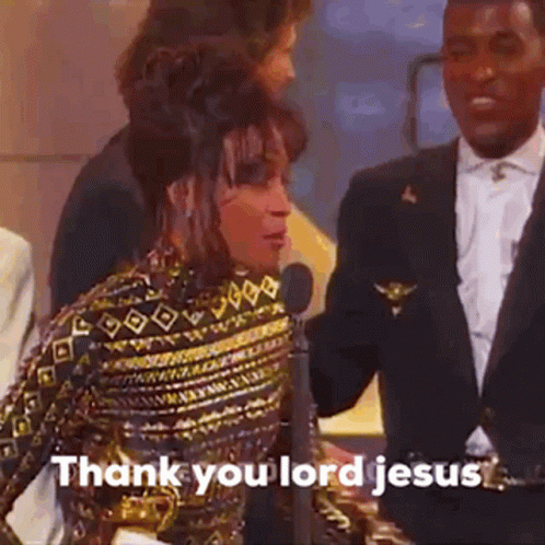 A Woman Is Standing In Front Of A Microphone While A Man In A Suit Talks To Her . GIF