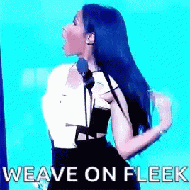 A Woman Is Standing In Front Of A Microphone With The Words `` Weave On Fleek '' Written On The Screen . GIF