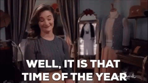 A Woman Is Standing In Front Of A Mirror In A Room . GIF