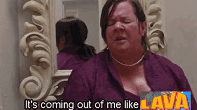 A Woman Is Standing In Front Of A Mirror With The Words It 'S Coming Out Of Me Like Lava Above Her GIF