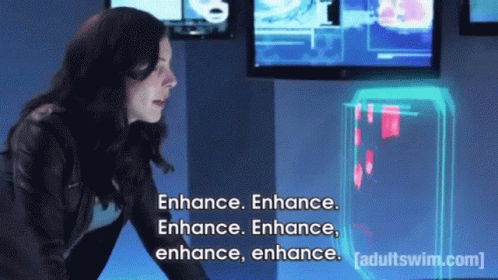 A Woman Is Standing In Front Of A Screen That Says Enhance Enhance Enhance Enhance Enhance Enhance GIF