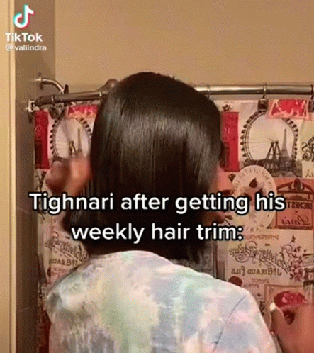 A Woman Is Standing In Front Of A Shower Curtain While Getting Her Hair Trimmed . GIF