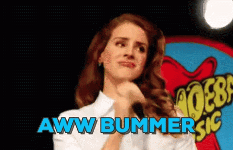 A Woman Is Standing In Front Of A Sign That Says Aww Bummer Sic GIF