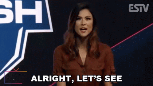 A Woman Is Standing In Front Of A Sign That Says Let 'S See . GIF