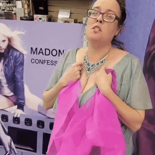 A Woman Is Standing In Front Of A Sign That Says Madon Confess GIF