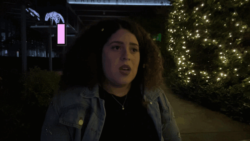 A Woman Is Standing In Front Of A Sign That Says Move On It GIF