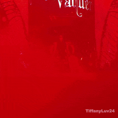 A Woman Is Standing In Front Of A Sign That Says Stephanie Varquez GIF