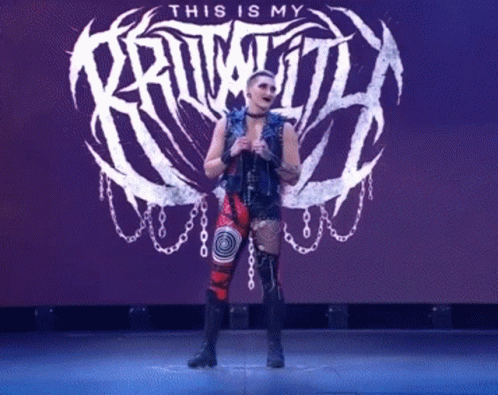 A Woman Is Standing In Front Of A Sign That Says " This Is My Kruwitt " GIF