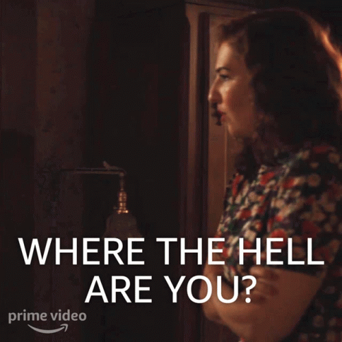 A Woman Is Standing In Front Of A Sign That Says Where The Hell Are You GIF