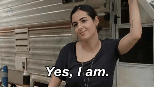 A Woman Is Standing In Front Of A Trailer And Says Yes I Am GIF