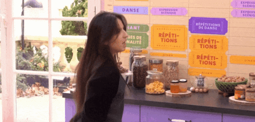 Woman Standing In Front Of Repetitions De Danse Sign GIF