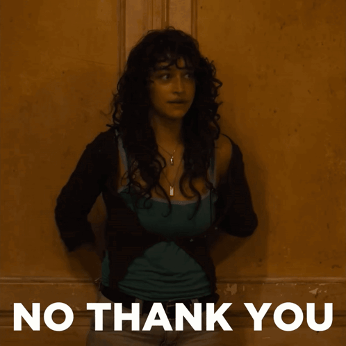 A Woman Is Standing In Front Of A Wall With The Words No Thank You On The Bottom GIF