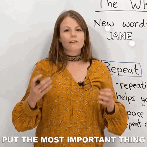 A Woman Is Standing In Front Of A White Board With The Words Put The Most Important Thing On It . GIF