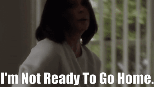 A Woman Is Standing In Front Of A Window And Says I 'M Not Ready To Go Home GIF
