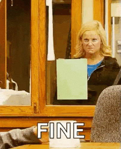A Woman Is Standing In Front Of A Window Holding A Piece Of Paper And The Word Fine Is On The Table . GIF