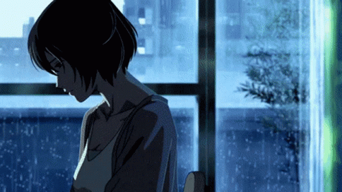 A Woman Is Standing In Front Of A Window With A Blue Background GIF