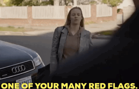 A Woman Is Standing In Front Of An Audi Car And Talking To A Man . GIF