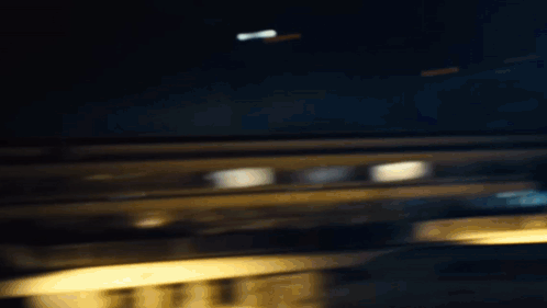 A Woman Is Standing In The Dark Wearing A Ripped Shirt And Black Pants . GIF