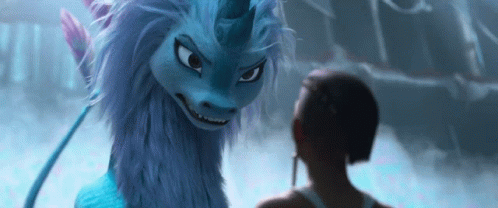 A Woman Is Standing Next To A Blue Dragon With A Unicorn Horn . GIF
