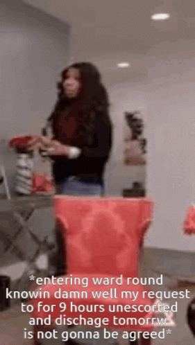 Woman Standing Next To Red Trash Can GIF