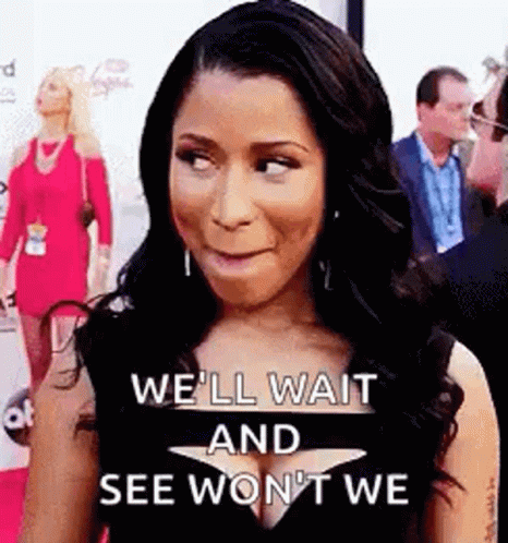 A Woman Is Standing On A Red Carpet And Making A Face . GIF