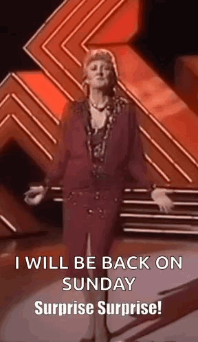 A Woman Is Standing On A Stage With Her Arms Outstretched And Says `` I Will Be Back On Sunday Surprise Surprise ! '' GIF