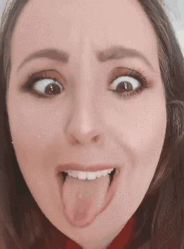 A Woman Is Sticking Her Tongue Out And Making A Funny Face GIF