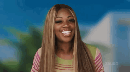 A Woman Is Sticking Her Tongue Out In Front Of A Blue Background GIF