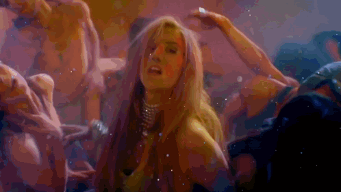 A Woman Is Surrounded By A Group Of Men In A Dark Room GIF