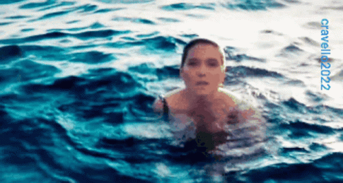 A Woman Is Swimming In The Ocean With The Year 2022 On The Bottom Right GIF
