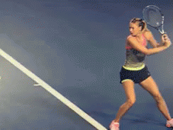 A Woman Is Swinging A Tennis Racquet On A Tennis Court With A Sign That Says Florida GIF