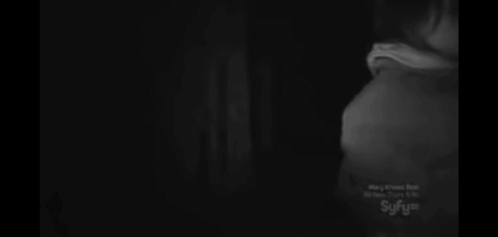 A Woman Is Taking A Picture With A Camera In The Dark GIF