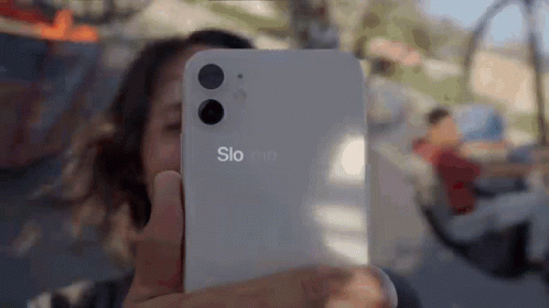 A Woman Is Taking A Selfie With A Phone That Says Slo Mo GIF