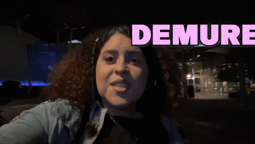a woman is taking a selfie with the words demure behind her