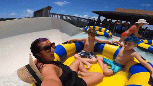 A Woman Is Taking A Selfie With Two Children On A Raft GIF