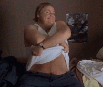 A Woman Is Taking Off Her Shirt And Smiling GIF