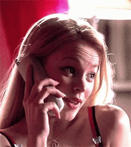 A Woman Is Talking On A Cell Phone And Making A Funny Face GIF