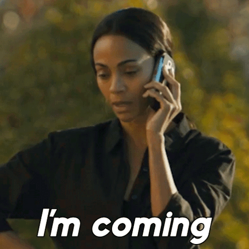 A Woman Is Talking On A Cell Phone And Says `` I 'M Coming '' GIF
