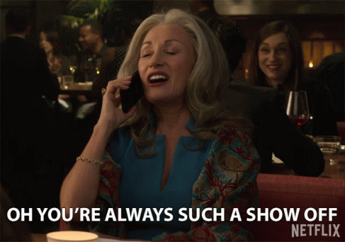 A Woman Is Talking On A Cell Phone And Says Oh You 'Re Always Such A Show Off GIF