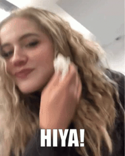 A Woman Is Talking On A Cell Phone And The Words Hiya Are On The Screen GIF
