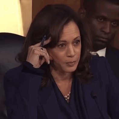 A Woman Is Talking On A Cell Phone While Sitting In A Chair . GIF