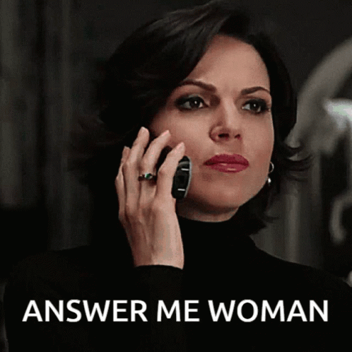 A Woman Is Talking On A Cell Phone With The Words Answer Me Woman Below Her GIF