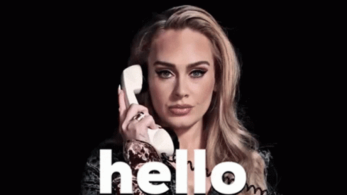 A Woman Is Talking On A Telephone With The Word Hello Written On The Bottom GIF