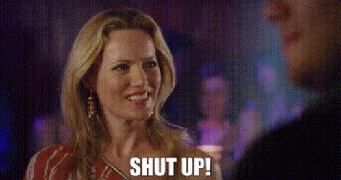 A Woman Is Talking To A Man At A Party And Says `` Shut Up '' . GIF