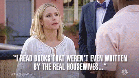 A Woman Is Talking To A Man In A Suit And Bow Tie While A Quote Is Displayed . GIF