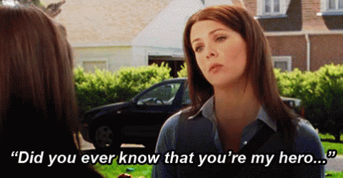 A Woman Is Talking To Another Woman In Front Of A Car And Says `` Did You Ever Know That You 'Re My Hero . '' GIF