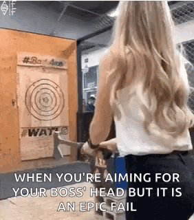 A Woman Is Throwing An Axe At A Target In A Room . GIF